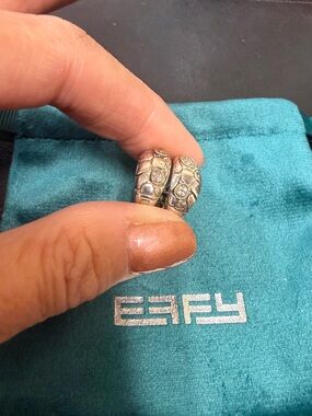 Effy huggie Sterling silver hoops with gold trim around the diamonds.